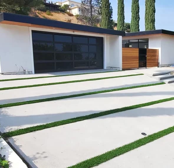 Concrete slab driveway with artificial turf joints, built by T&N Remodeling in Encino
