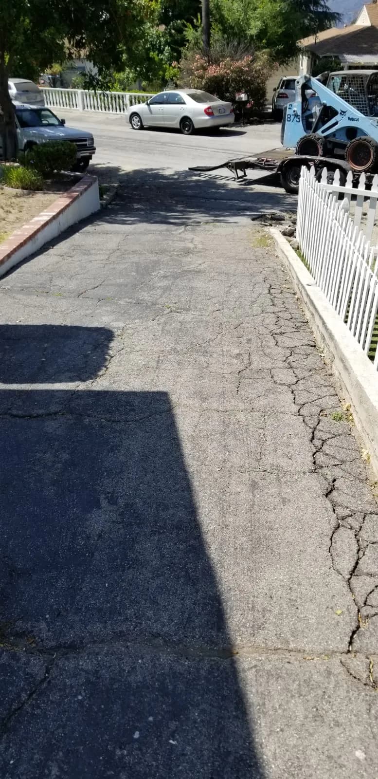 Cracked asphalt driveway before T&N Remodeling started work, Los Angeles